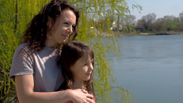 Mom-and-daughter-on-the-river-bank