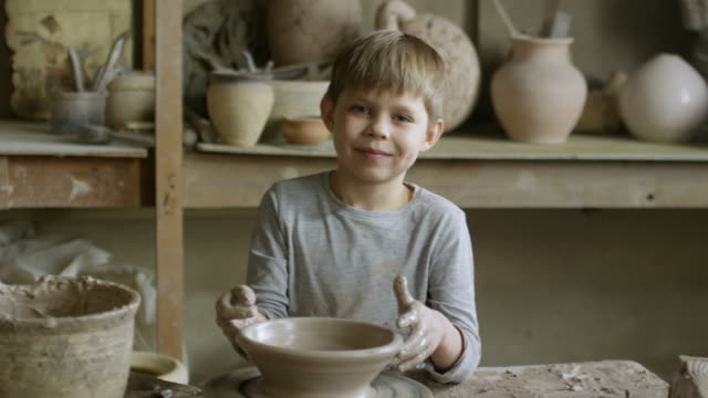 Boy-Posing-in-Pottery-Workshop