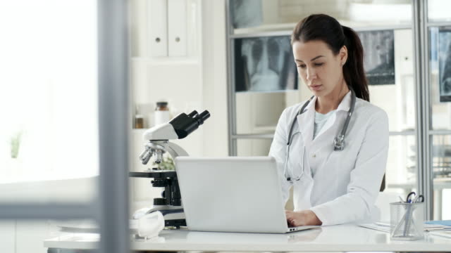 Female-Doctor-Typing-on-Laptop-Computer