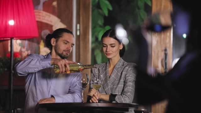 Beautiful-Couple-On-Romantic-Date-Drinking-Wine-At-Restaurant