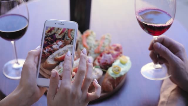 Food-And-Drink-Photo.-Woman-Looking-At-Pictures-On-Phone-Screen