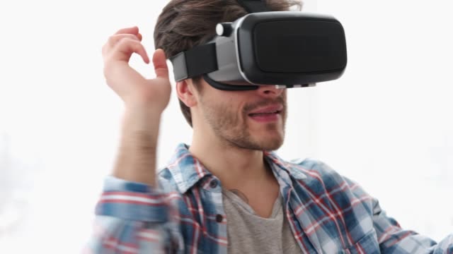 Man-having-fun-playing-game-on-virtual-reality-headset
