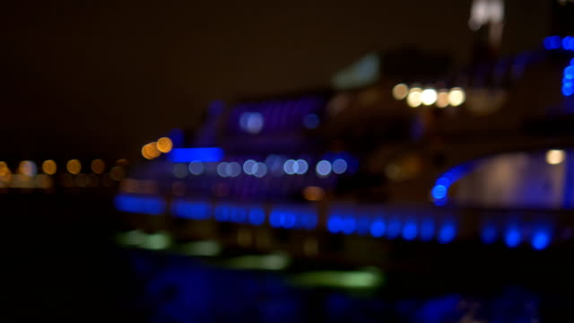 The-ship,-adorned-with-lights,-floats-along-the-river.-Not-in-Focus---Intentionally