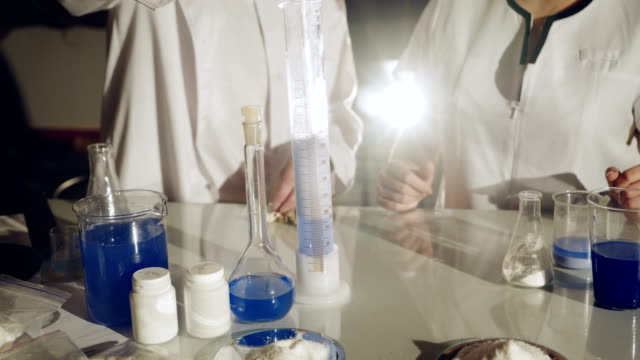 Scientist-working-with-chemical-reaction-in-chemistry-lab.