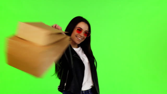 Happy-young-woman-posing-with-her-shopping-bags-on-chromakey