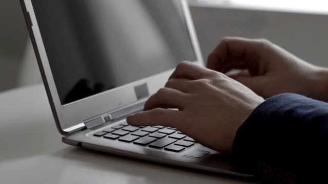 Man-typing-on-laptop
