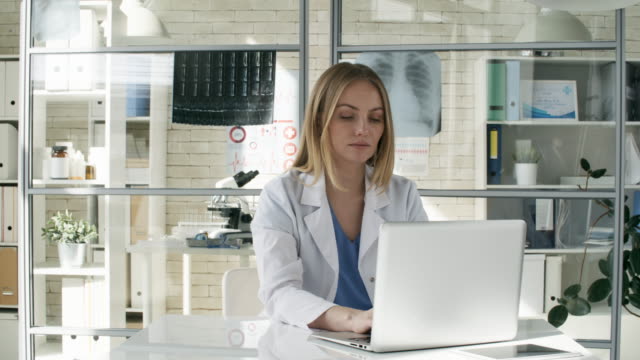 Caucasian-Doctor-Typing-on-Computer-in-Clinic