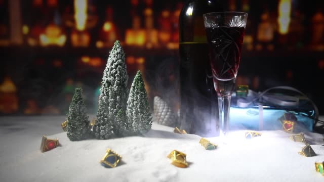 Glass-of-wine-with-Christmas-decoration.-Red-wine-in-crystal-glass-on-snow-with-creative-New-Year-artwork.-Copy-space