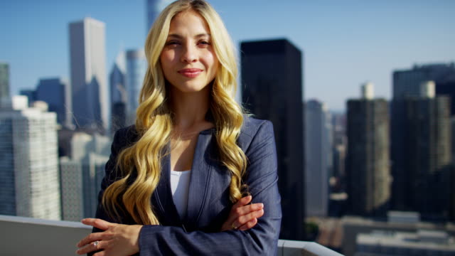 Portrait-of-Caucasian-American-businesswoman-on-skyscraper-rooftop