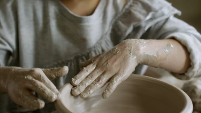 Little-Girl-Learning-to-Make-Pottery