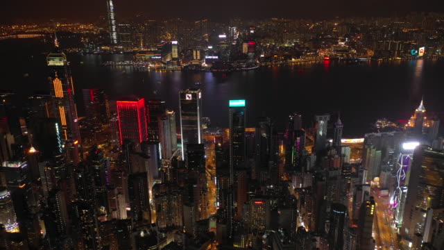 night-time-illuminated-hong-kong-cityscape-downtown-victoria-harbour-aerial-panorama-4k
