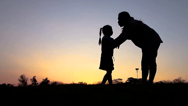 silhouette-of-the-mother-and-the-child-running-in-the-park