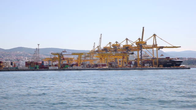 Industrial-Container-Cargo-freight-ship-with-working-crane-bridge-in-shipyard