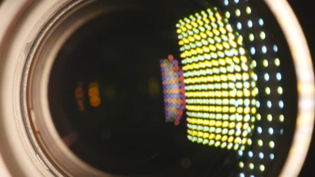 Video-camera-lens,-showing-zoom-and-glare,-turns,-close-up