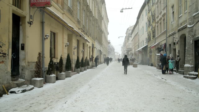 LVOV,-UKRAINE---Winter-2018-Timelapse:-The-snowy-weather-in-old-city-Lviv-in-Ukraine.-People-are-walking-along-the-narrow-old-street.