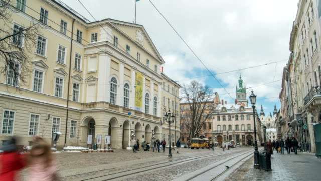 LVOV,-UKRAINE---Winter-2018-Timelapse:-Center-of-old-city-Lviv,-Ukraine.-Time-lapse-of-moving-people-through-the-Market-Square-(Ploshcha-Rynok).-Clouds-are-moving-quickly.-Last-day-of-winter.