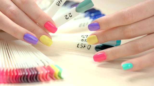 Set-of-multicolored-nail-in-female-hands.