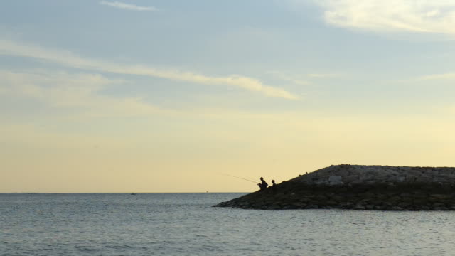 Fisherman-on-Dyke-in-Sunset