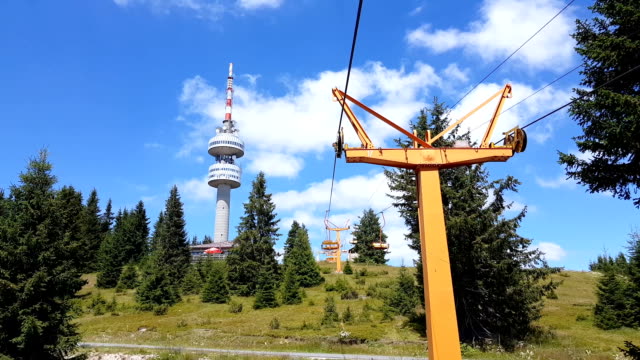 Empty-chair-lift-ascending-in-Pamporovo-winter-mountain-ski-resort-in-Bulgaria-during-summer.