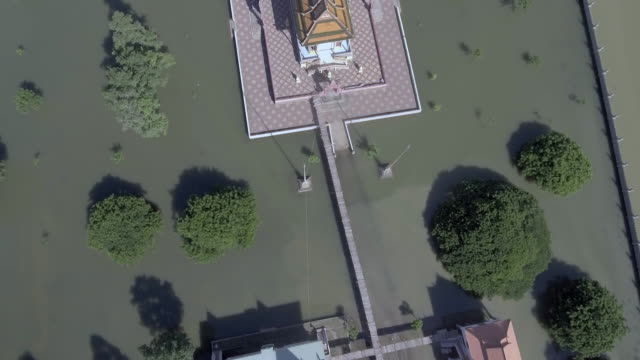 Aerial-overhead-view-of-a-pagoda-is-surrounded-by-floodwaters