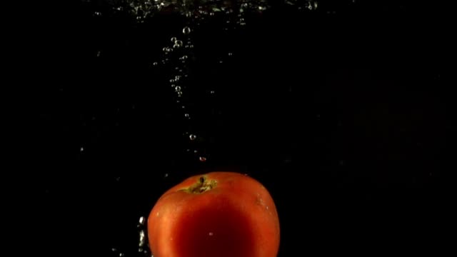Falling-of-tomato-in-water.-Slow-motion.