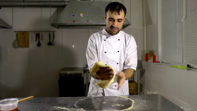 Cook-in-the-kitchen-preparing-pizza-dough.-A-man-prepares-pastries