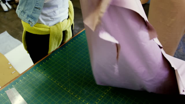 Fashion-designer-checking-cloth-in-fashion-studio-4k
