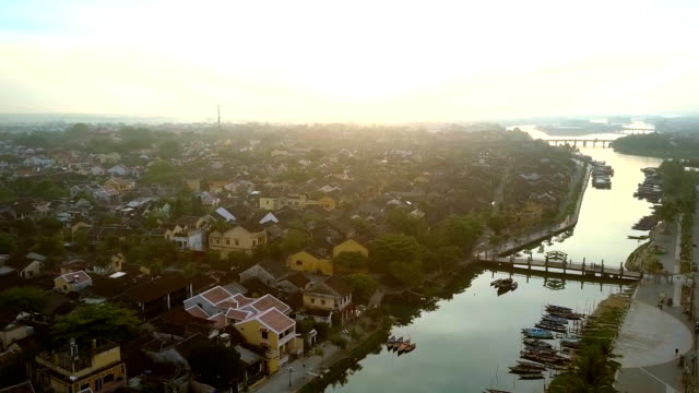 flight-above-river-with-bridges-boats-in-ancient-town-Hoian
