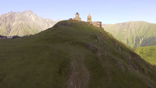 aerial.-Gergeti-orthodox-church-high-in-the-mountains,-Georgia
