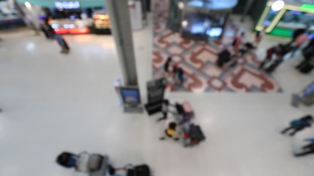 Top-view-of-abstract-blur-airport-terminal-with-commuter-crowd-of-people-and-passenger-walking-when-track-arriving-or-departing-flights,-Blurred-busy-Airport-Terminal-footage-concept.-Full-HD1920x1080