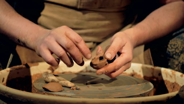 A-potter-manually-shapes-a-clay-spoon.