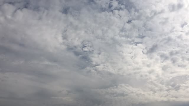 Cloudy-sky.-White-clouds-disappear-in-the-hot-sun-on-blue-sky.-Time-lapse-motion-clouds-blue-sky-background.-Blue-sky-with-white-clouds-and-sun.