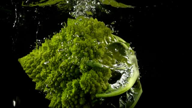 Falling-of-cabbage-of-broccoli-in-water.-Slow-motion.