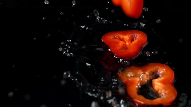 Falling-of-pieces-of-sweet-red-pepper.-Slow-motion.