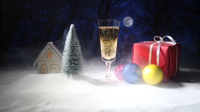 Glass-of-champagne-with-Christmas-decoration.-Traditional-winter-holiday-alcohol-drink-in-snow-with-creative-New-Year-artwork.-Copy-space