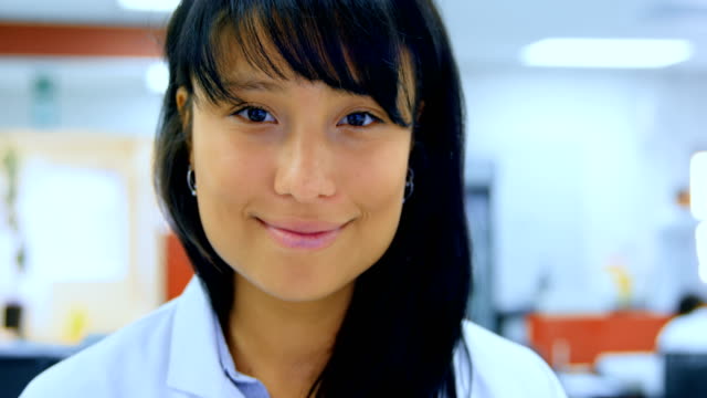 Female-scientist-analyzing-test-tube-in-laboratory-4k