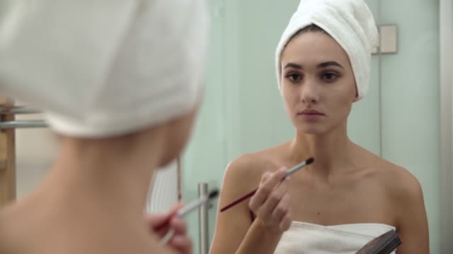 Makeup.-Woman-Applying-Eyeshadows-And-Looking-At-Mirror