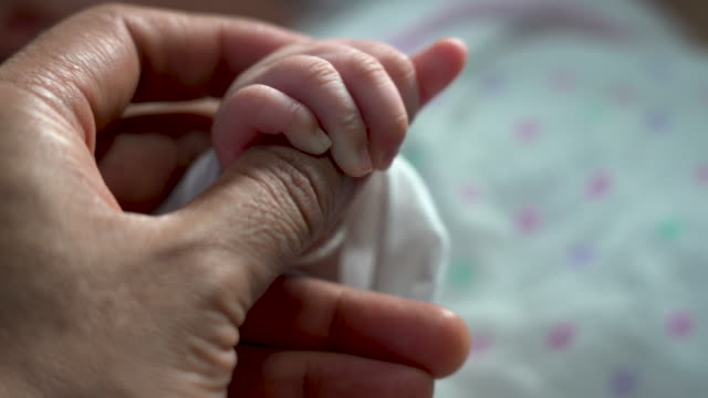 Baby-newborn-holding-mother-hand