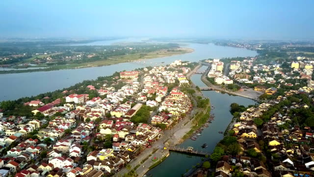 motion-above-channel-of-old-Hoian-against-wide-river