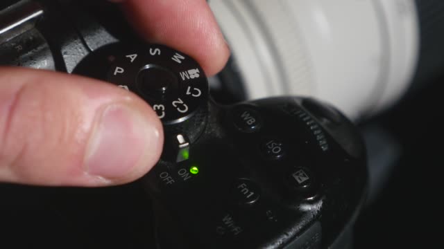 turning-the-settings-wheel-on-photo-camera