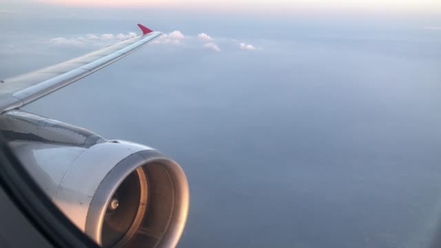 Wing-and-engine-of-airplane-flying-on-sky-and-cloud-on-beautiful-view