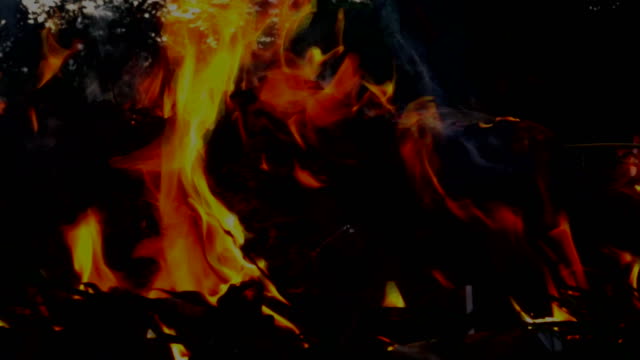 Slow-motion-flame-fire-and-smog-is-burning-garbage-or-waste--on-dark-background