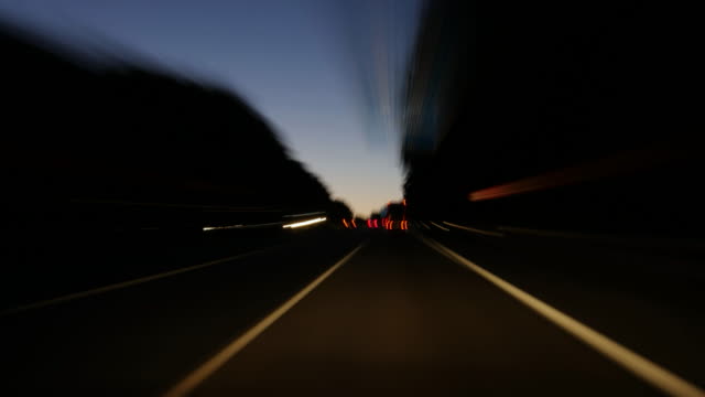 Driving-on-a-highway-at-dusk