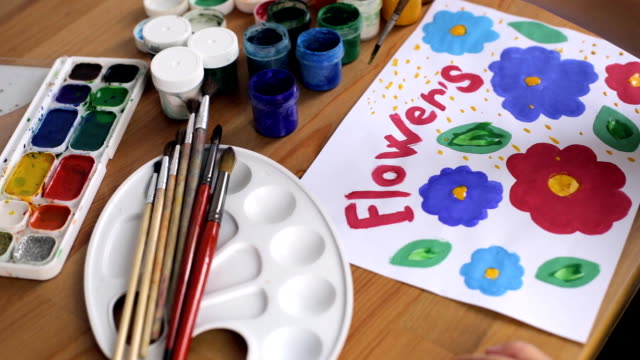 Child's-hand-draw-colorful-flowers