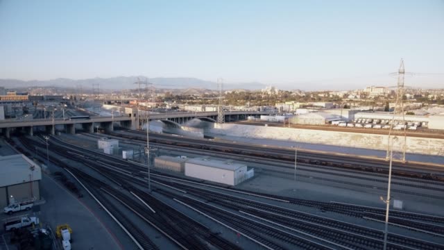 Aerial-shot-of-train-tracks-and-road-in-Los-Angeles,-CA