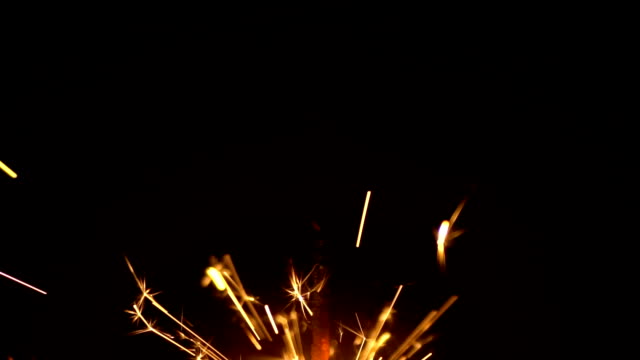 Slow-Motion-Yellow-Sparklers-is-Sparkling-On-Black-Background-Close-Up-3
