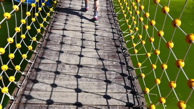 walking-on-the-suspension-bridge,-walking-on-the-rope-bridge