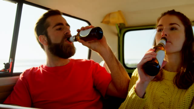 Young-couple-drinking-beer-in-van-4k