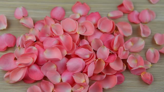 wooden-table-pink-rose-petals-hd-footage