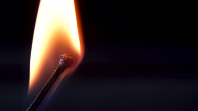 Burning-Match-And-Flame.-Safety-Match-close-up-on-a-black-background
